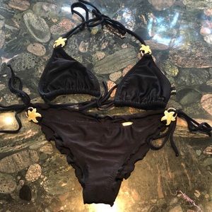 Luli Fama string bikini with ruched bottoms.